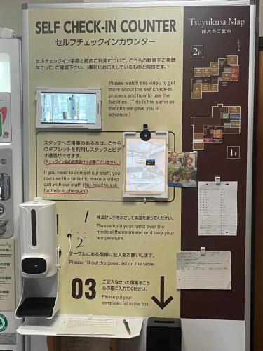 a sign for a self check in counter at Tsuyukusa in Takayama