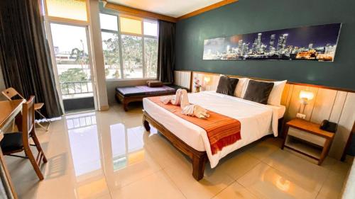 a bedroom with a large bed in a room at K2 Hotel @ Airport in Surat Thani