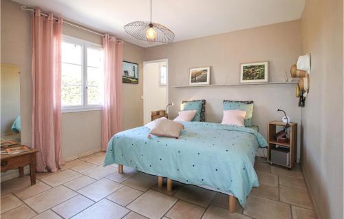 a bedroom with a bed with a blue comforter at Amazing Home In Montboucher Sur Jabron With Outdoor Swimming Pool in Montboucher-sur-Jabron