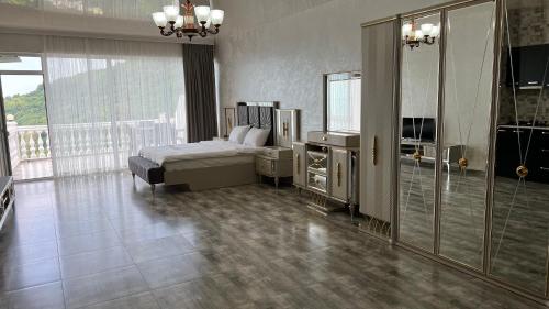 a bedroom with a bed and a dresser and a window at Zura palace in Kvariati