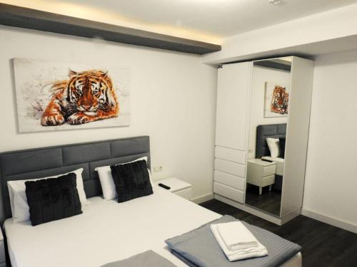 a bedroom with a bed with a painting of a tiger at Hotel Hecht in Feldkirch