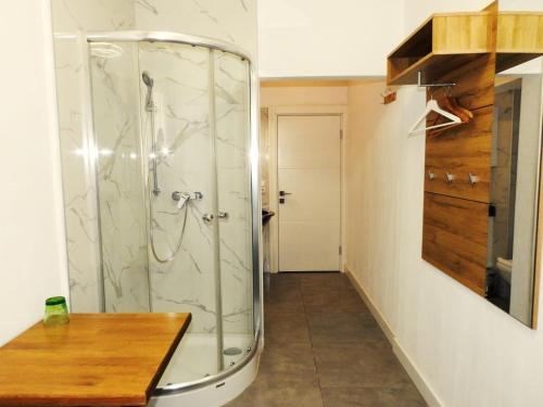 a shower with a glass door in a bathroom at Hotel Hecht in Feldkirch