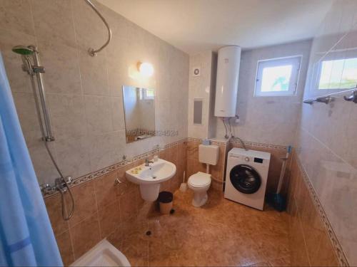a bathroom with a sink and a toilet and a shower at Fantastic Apartment in Sveti Vlas in Sveti Vlas
