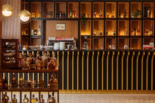 a bar with a lot of bottles of alcohol at Gloria Palace Hotel & SPA in Golem