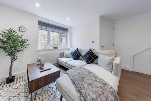 a living room with a couch and a table at Holiday Home Sleep 8 Central london 9elms in London