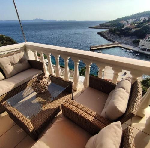 a balcony with a couch and a view of the ocean at Apartments Laus in Zavalatica