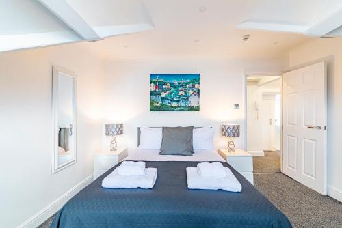a bedroom with a large bed with two towels at Greyfriars in Clacton-on-Sea