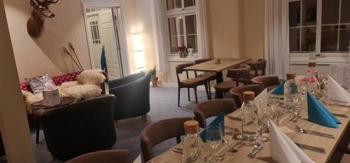a restaurant with tables and a teddy bear sitting on a couch at Villa Fregn in Ljørdal