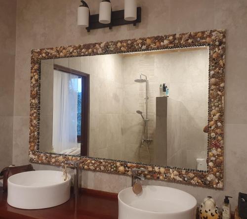a bathroom with a large mirror and a sink at Harbour View House in Port Elizabeth