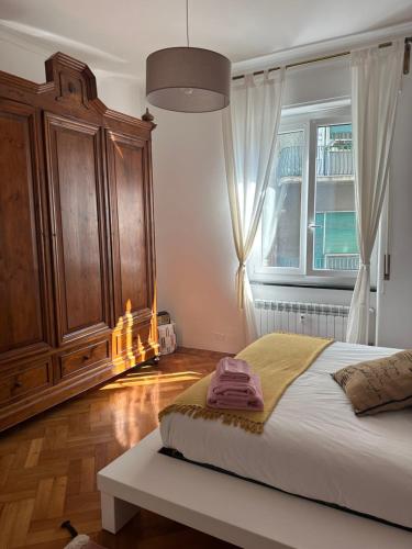 a bedroom with a large bed and a window at La dimora del capitano in Genoa