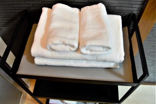 two towels on a shelf in a bathroom at Osaka U-Shuku in Osaka