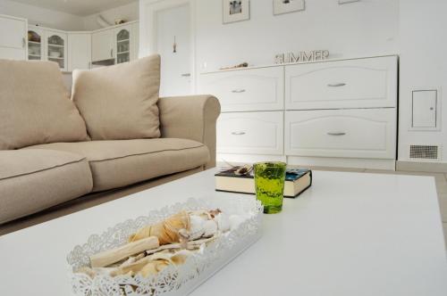 a living room with a couch and a table at Ferienhaus mit Meerblick & Pool in Baška - Villa-Planina in Baška