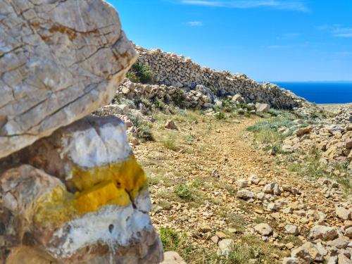 a rock on the side of a mountain at Ferienhaus mit Meerblick & Pool in Baška - Villa-Planina in Baška