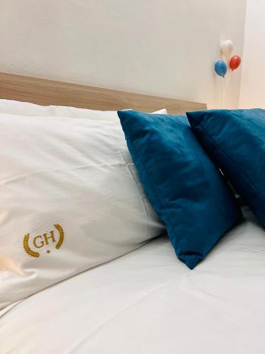 a bed with blue and white pillows on it at Gegix's House Rho in Rho