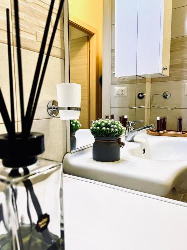 a bathroom with a sink and a potted plant on a counter at Gegix's House Rho in Rho