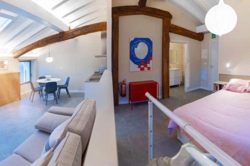 a bedroom and a living room with a bed and a table at Apartamentos en Baztan HIRU KABI, BAGA in Lecároz