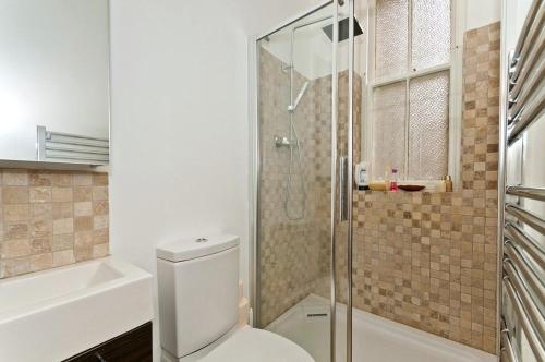 a bathroom with a toilet and a glass shower at Blue Seas in North Berwick