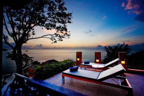 a living room with a view of the water at Sri Panwa Phuket Luxury Pool Villa Hotel - SHA Plus in Panwa Beach