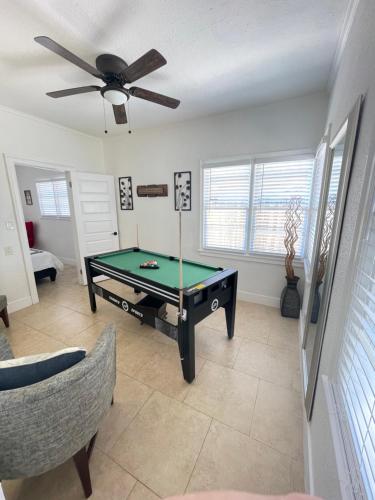 a living room with a pool table and a ceiling fan at Crest Lake Beach House in Clearwater