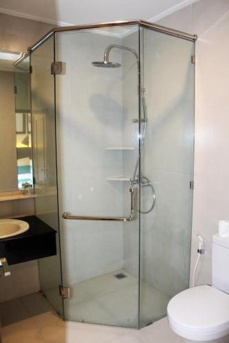 a glass shower in a bathroom with a toilet at Bali Agung Village - CHSE Certified in Seminyak