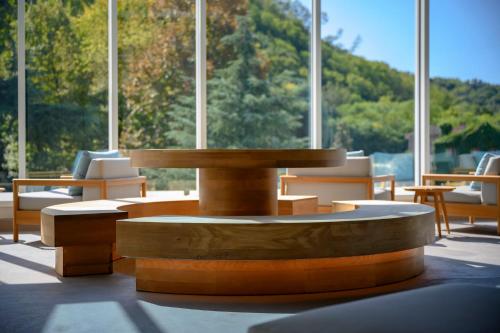 a table and chairs in a room with windows at Terme Preistoriche Resort & Spa in Montegrotto Terme
