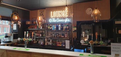 a bar in a pub with a lot of alcohol at The Connaught Hotel Wolverhampton in Wolverhampton