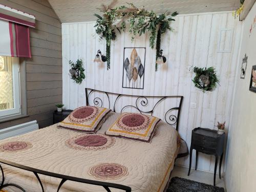 a bedroom with a bed with two pillows on it at Le Paddock Du Val De Lys in Blessy