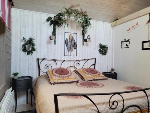 a bedroom with a bed with two pillows on it at Le Paddock Du Val De Lys in Blessy