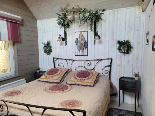 a bedroom with a bed with two pillows on it at Le Paddock Du Val De Lys in Blessy