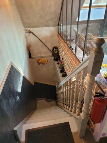 a stairway with a stair case and a stair case at Le Paddock Du Val De Lys in Blessy