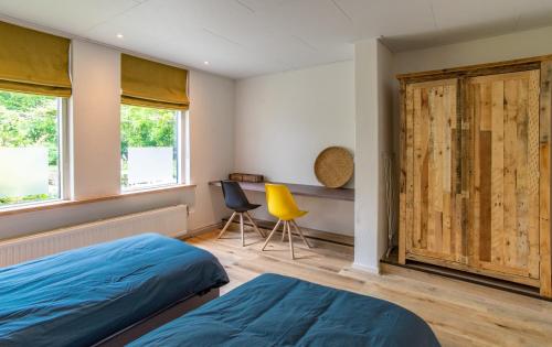 a bedroom with two beds and a sliding door at Landgoed Wilgenheerd in Wehe-den Hoorn