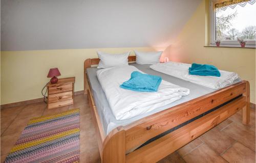 a bed with two blue towels on top of it at Nice Home In Wohlenberg With Kitchen in Wohlenberg