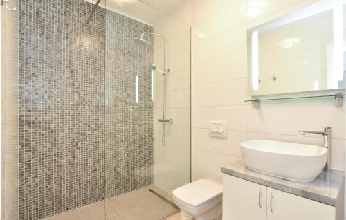 a bathroom with a shower and a sink and a toilet at Stunning Home In Okrug Gornji With Heated Swimming Pool in Trogir