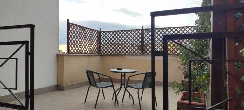 a balcony with two chairs and a table on a balcony at WiSaRelax in Brusciano