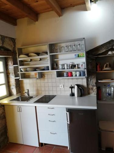 a kitchen with a sink and a counter top at The Yellow Boat House in Klima
