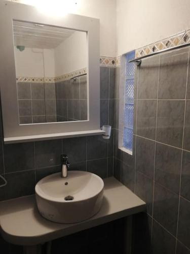 a bathroom with a sink and a mirror at The Yellow Boat House in Klima