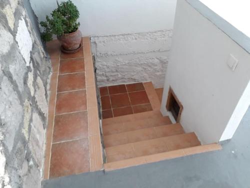 a set of stairs in a room with a tile floor at The Yellow Boat House in Klima