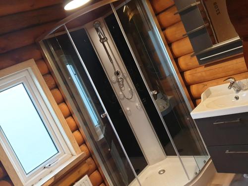 a bathroom with a shower and a sink at Akureyri Loghouse in Akureyri