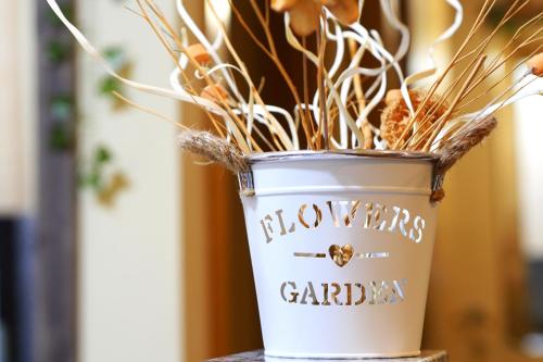 a white vase filled with dried plants on a table at Grace, apartamento con terraza y vistas in Talarn