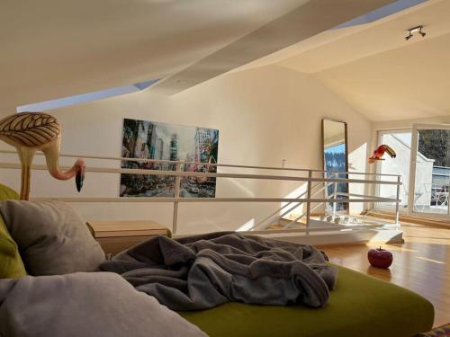 a room with a bed with a blanket on the floor at Sonnige Loft mit Terrasse, Ladestation für Elektrofahrzeuge in Schindellegi