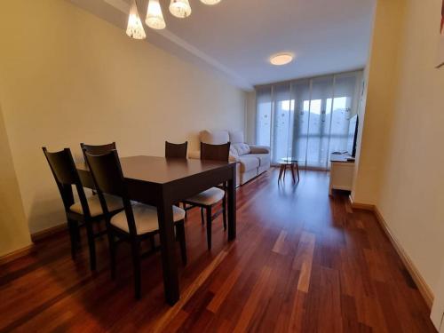a dining room table and chairs in a living room at 24A01 Apartamento Cabrales in Arenas de Cabrales