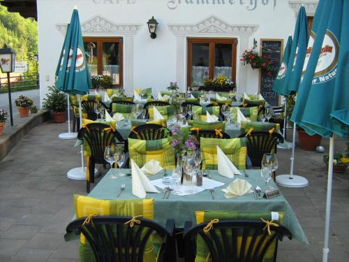 a group of tables with chairs and umbrellas at Hotel Kammerhof in Mariastein