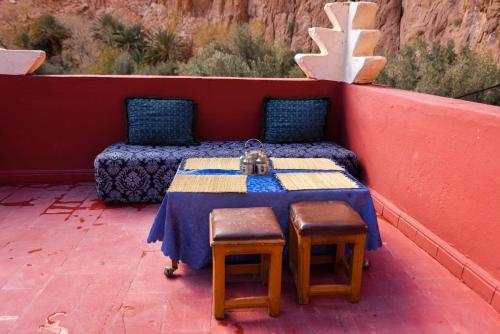 a table and two chairs sitting on a patio at Etoile des Gorges in Aït Baha