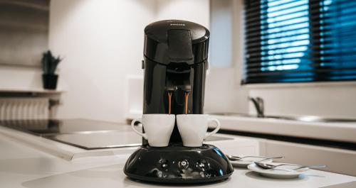 a black coffee maker sitting on a kitchen counter at MOLO house - cosy house with sunny garden and bbq in silent surroundings - near the BEACH - ideal for families and quiet groups - 15 km from BRUGES in Blankenberge