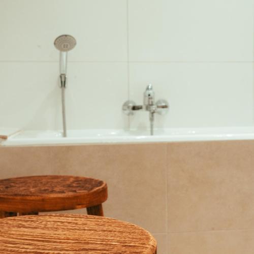 a bathroom with a sink and a wooden stool at MOLO house - cosy house with sunny garden and bbq in silent surroundings - near the BEACH - ideal for families and quiet groups - 15 km from BRUGES in Blankenberge