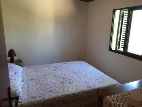 Un pat sau paturi într-o cameră la Casa Férias Costa Vicentina
