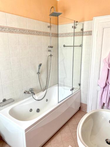 a bathroom with a shower and a tub and a sink at Villa Magnolia - Lake Como in Lenno