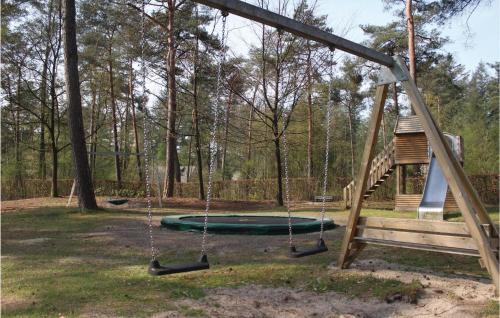 a swing set in a park with a playground at Reehut in Ommen