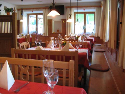 a restaurant with tables and chairs with red table cloth at Hotel Kammerhof in Mariastein