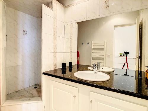 a bathroom with a sink and a shower at 1 Bedroom flat with Balcony Cannes Center Croisette 6ppl in Cannes